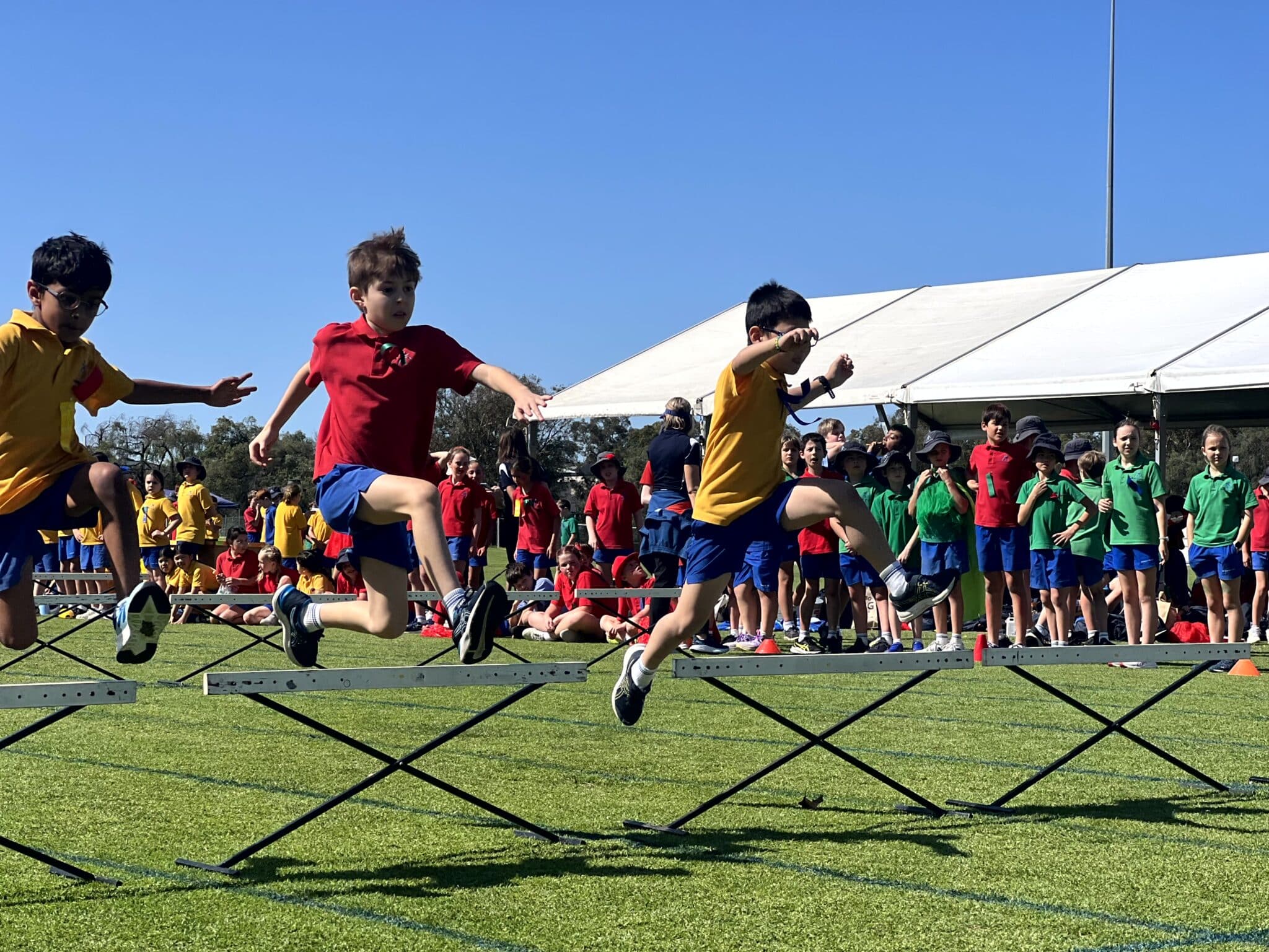 Children running hurdles